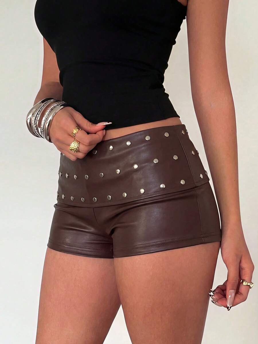 Women's studded PU ultra low waist mini shorts with zipper fly closure, skinny fit, mini length, and plain unlined design.