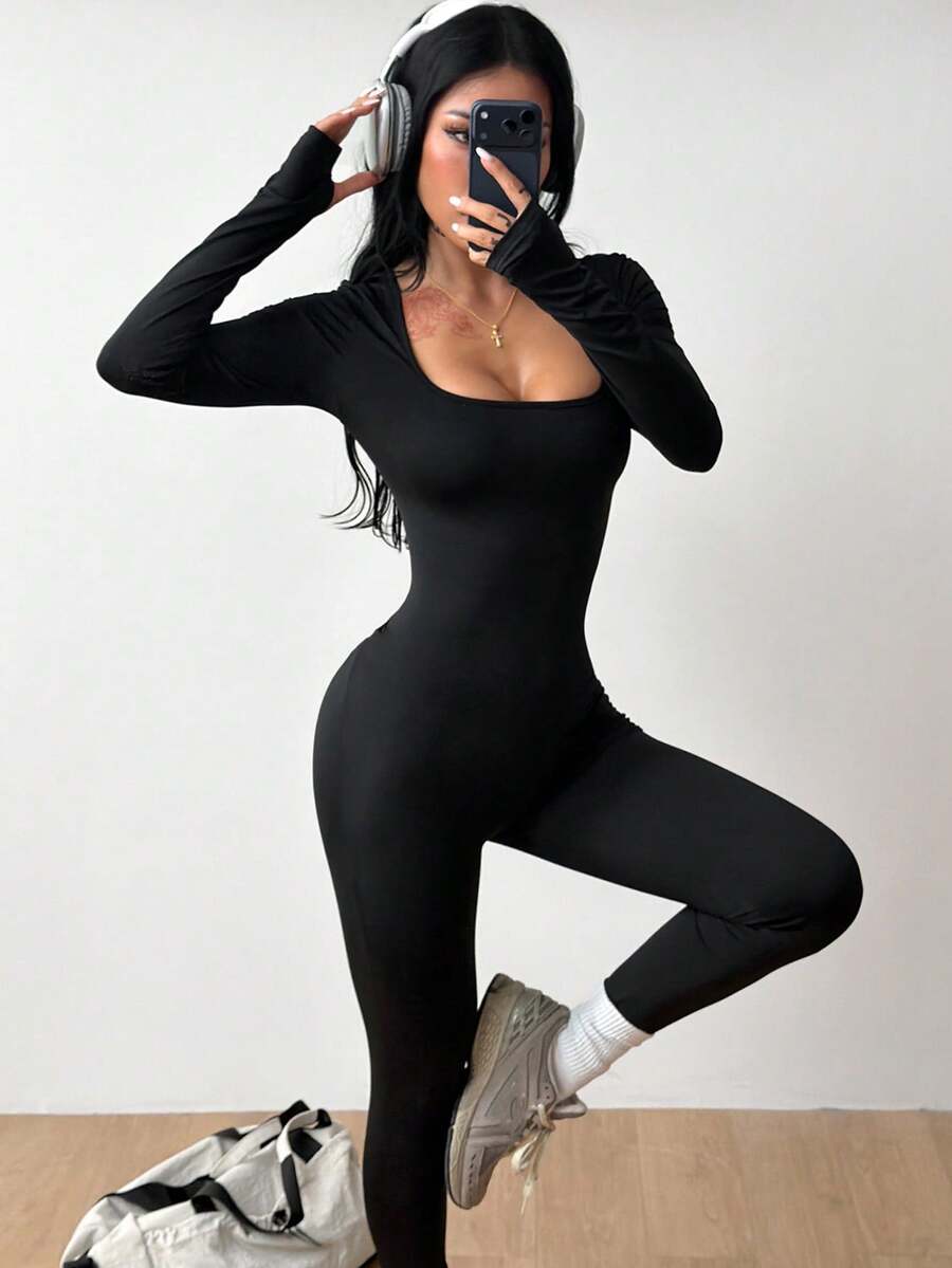 Black square neck long sleeve sport jumpsuit in rib-knit fabric with slim fit unitard silhouette for women.