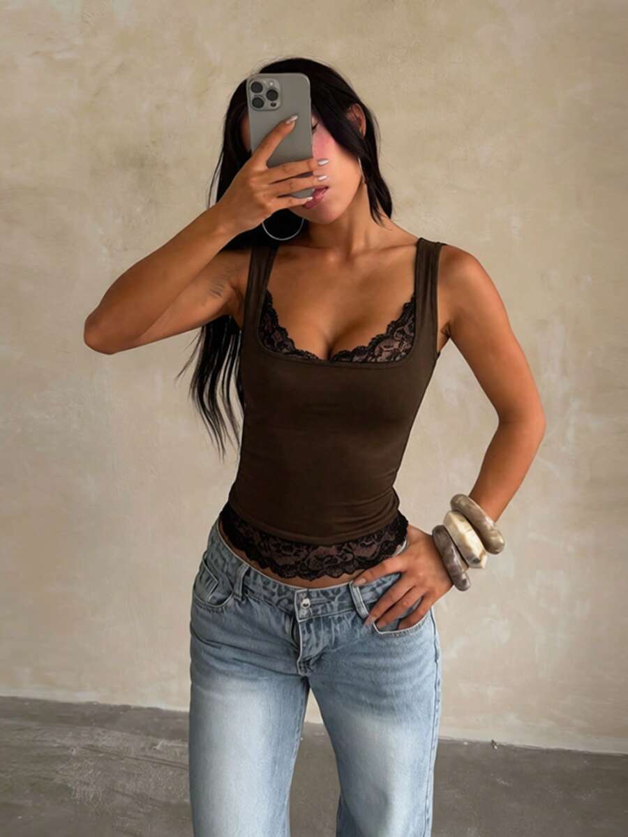 Women's white sleeveless crop tank top with contrast lace details, strap neckline, and graphic plant pattern in a slim fit.