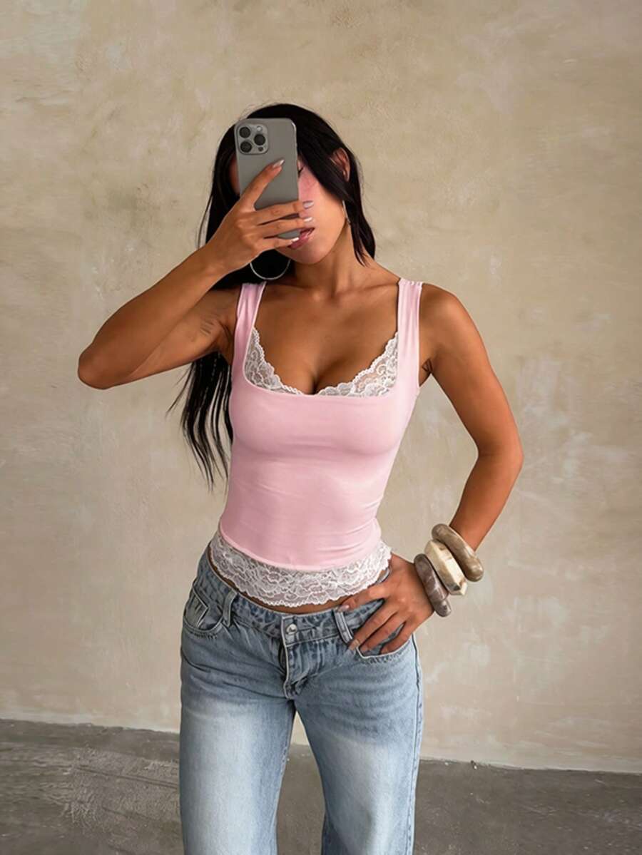 Women's white sleeveless crop tank top with contrast lace details, strap neckline, and graphic plant pattern in a slim fit.