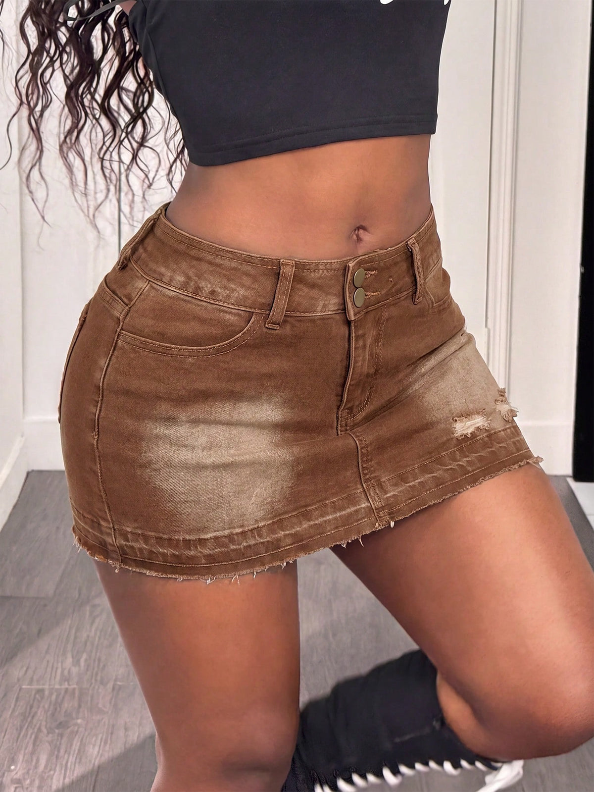 Women's black low waist bodycon mini skirt with button detail, pockets, and zipper closure