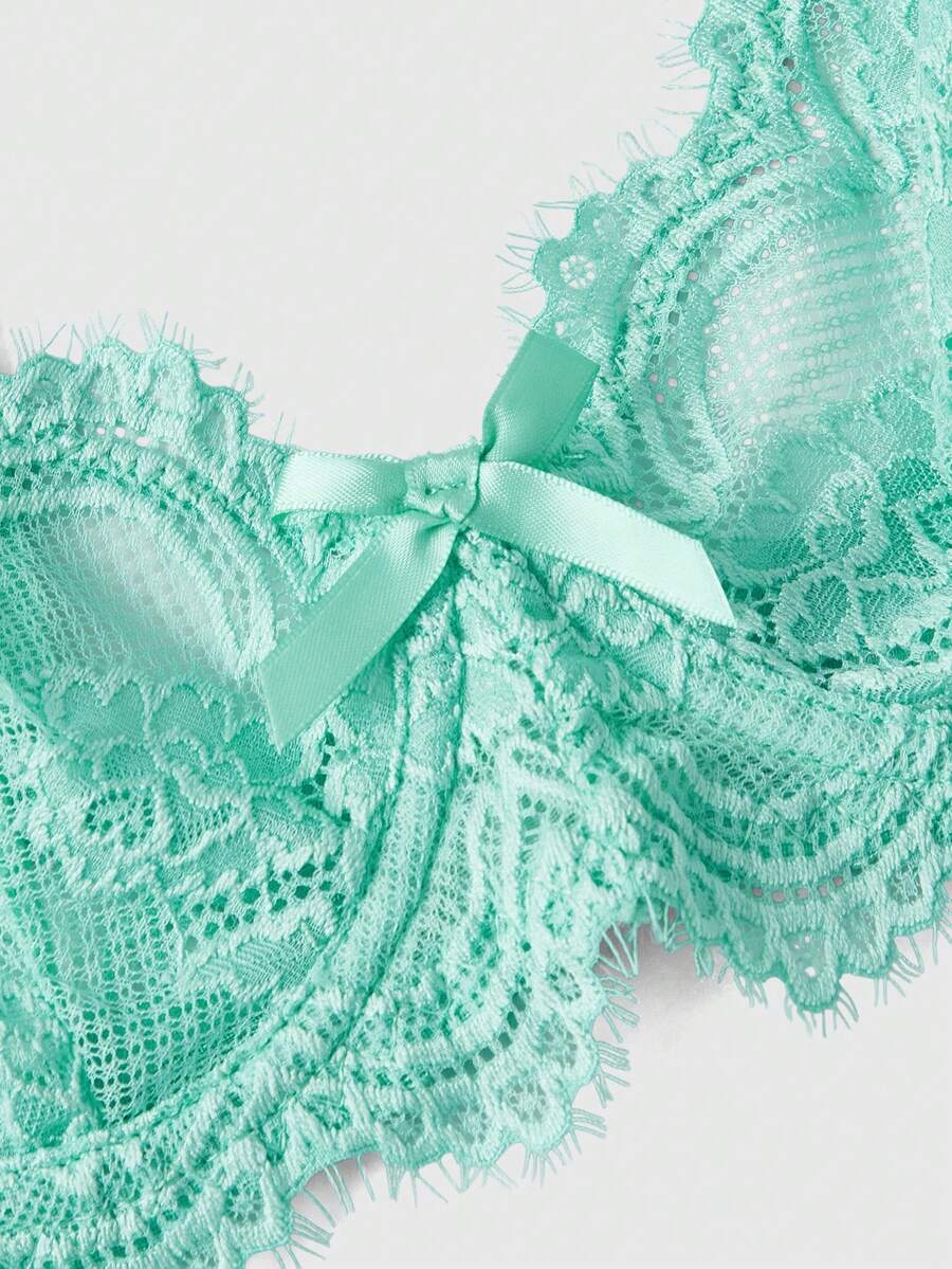 Sheer floral lace underwire triangle bra for women featuring adjustable straps and plunge cup design.