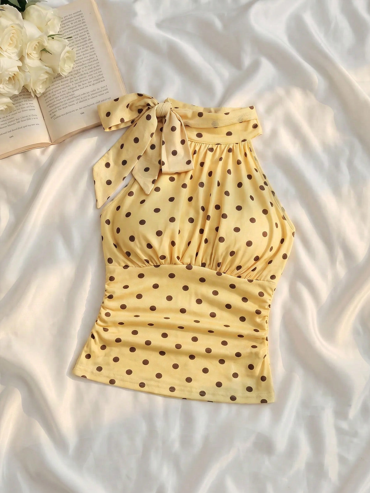 Women's sleeveless high-neck halter crop top in apricot with ruched knot front detailing.