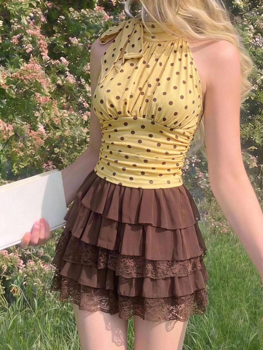 Women's sleeveless high-neck halter crop top in apricot with ruched knot front detailing.