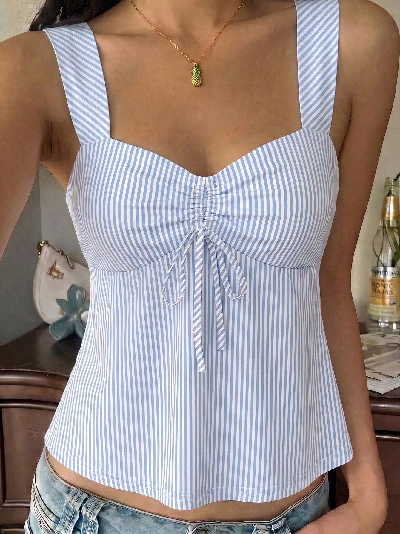 Women's striped camisole tank top with strap neckline, backless knot detail, cold shoulder styling, slim fit, and flared hem for casual vacation or daily wear.