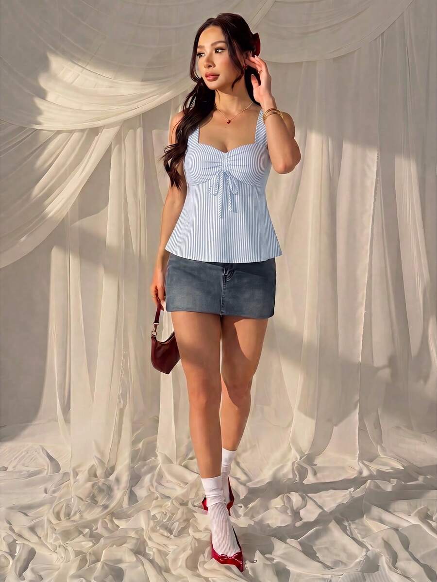 Women's striped camisole tank top with strap neckline, backless knot detail, cold shoulder styling, slim fit, and flared hem for casual vacation or daily wear.