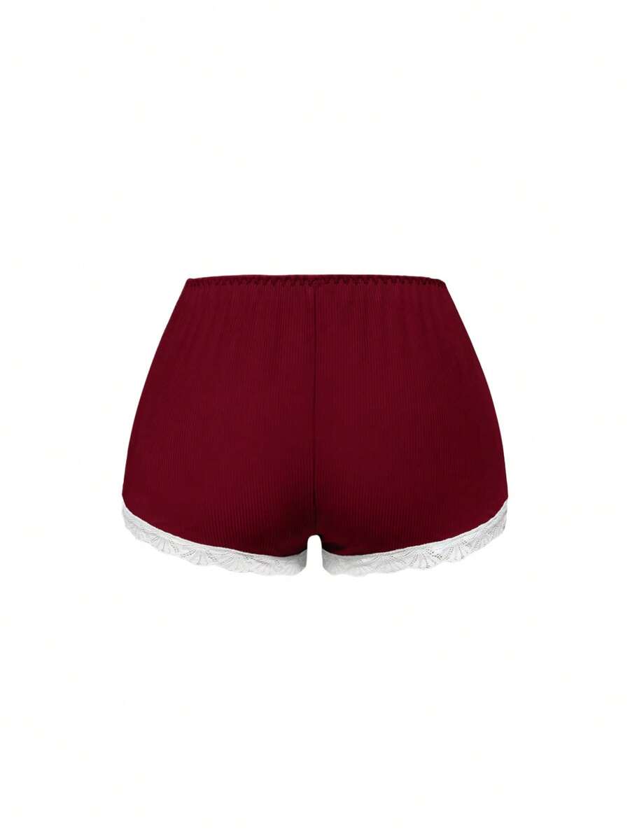 Ribbed lace camisole and shorts pajama set with spaghetti straps, bow detail, and contrast lace trim