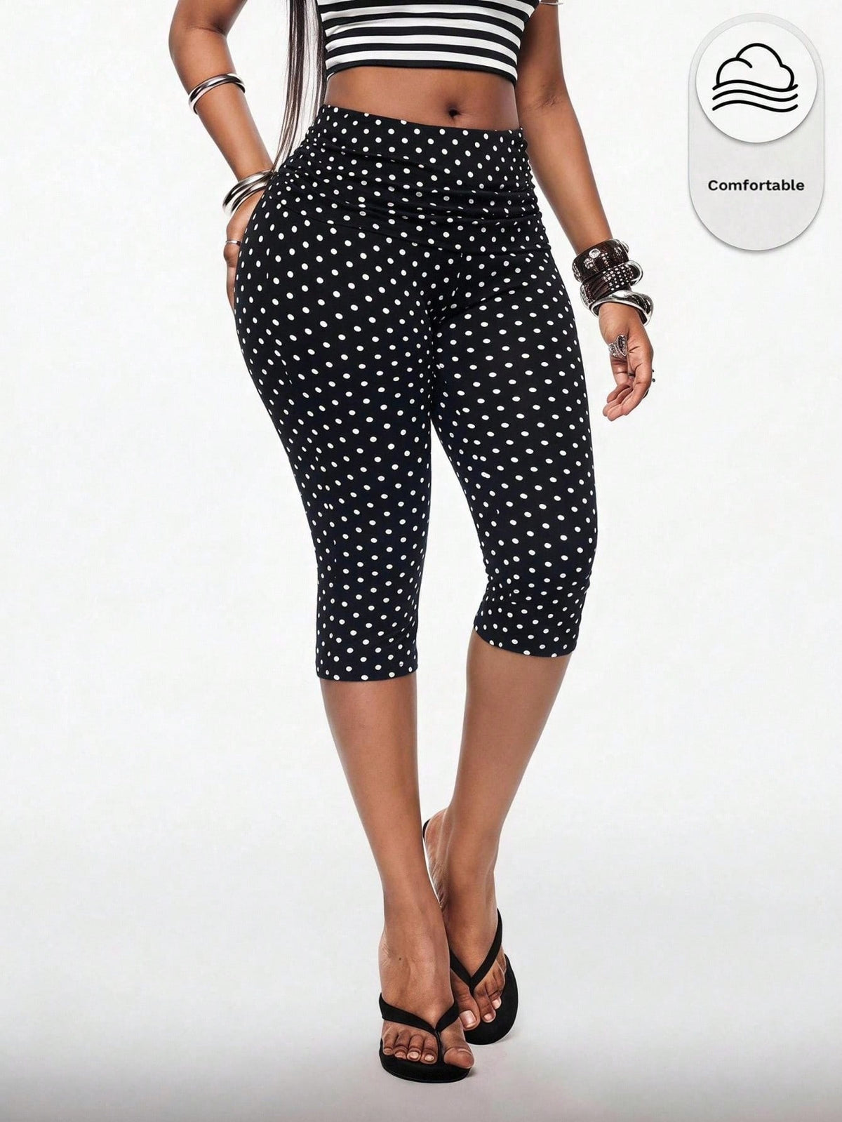 Women's polka dot cropped capri pants in a black and white geometric pattern with an elastic drawstring waist and skinny fit.