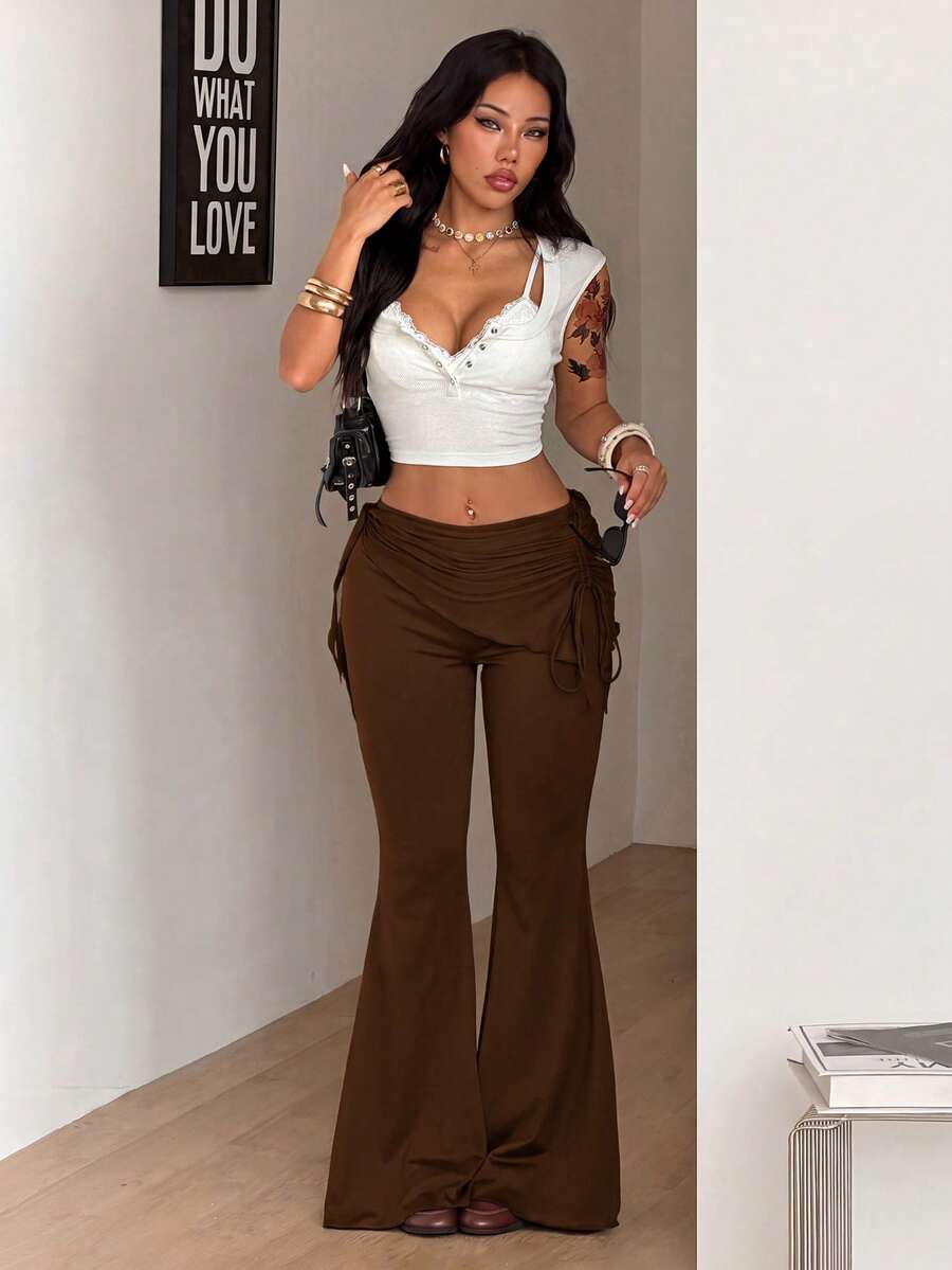 Women's black low rise flare pants with split hem detailing and stretchy knit fabric