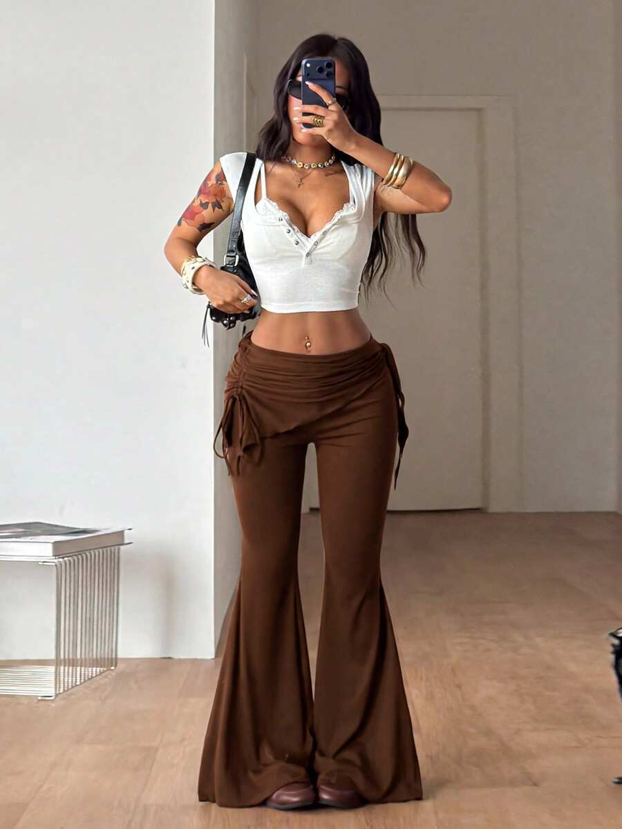 Women's black low rise flare pants with split hem detailing and stretchy knit fabric