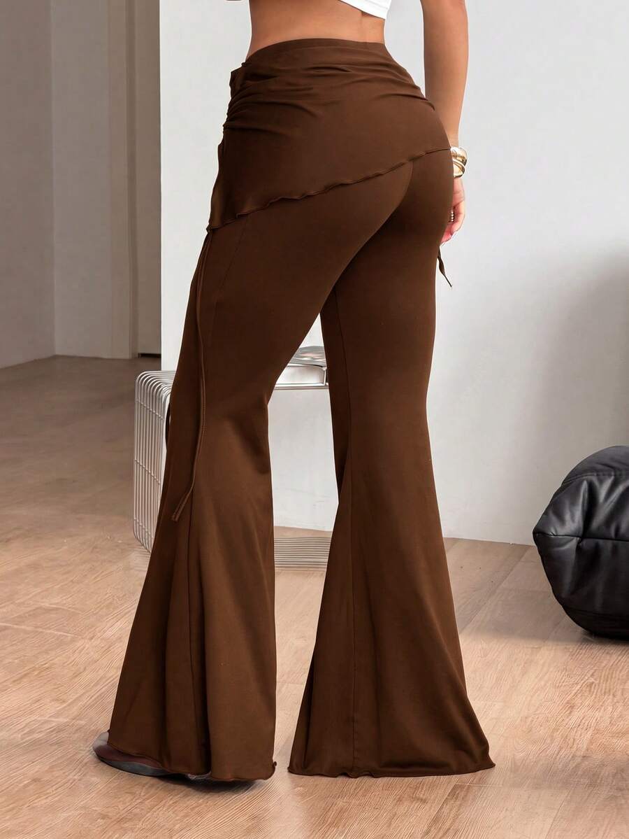 Women's black low rise flare pants with split hem detailing and stretchy knit fabric