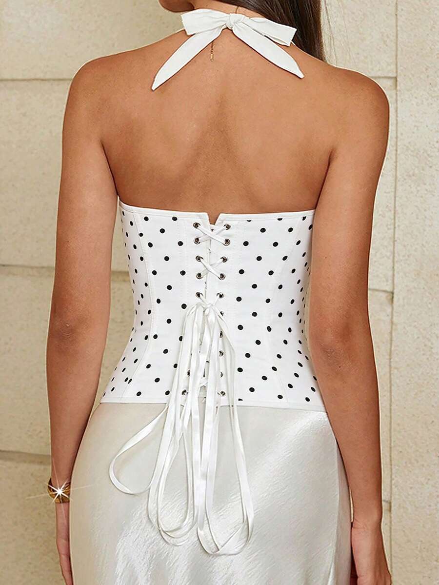 White halter sleeveless cropped camisole top featuring a boned cup detail bust, slim fit waist, and lace-up back closure.