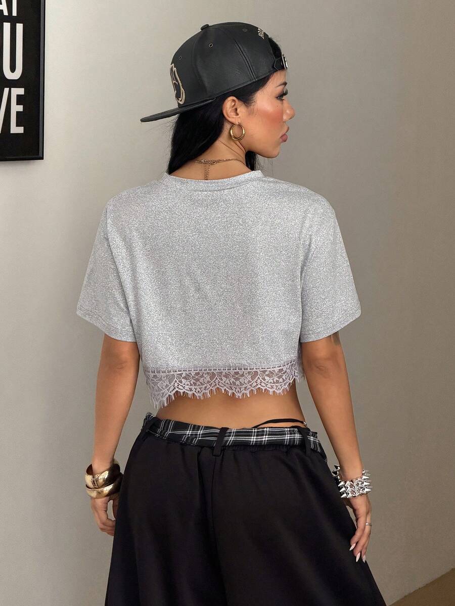 Women's short sleeve crop top with a round neckline and drop shoulder design in black knitted fabric.