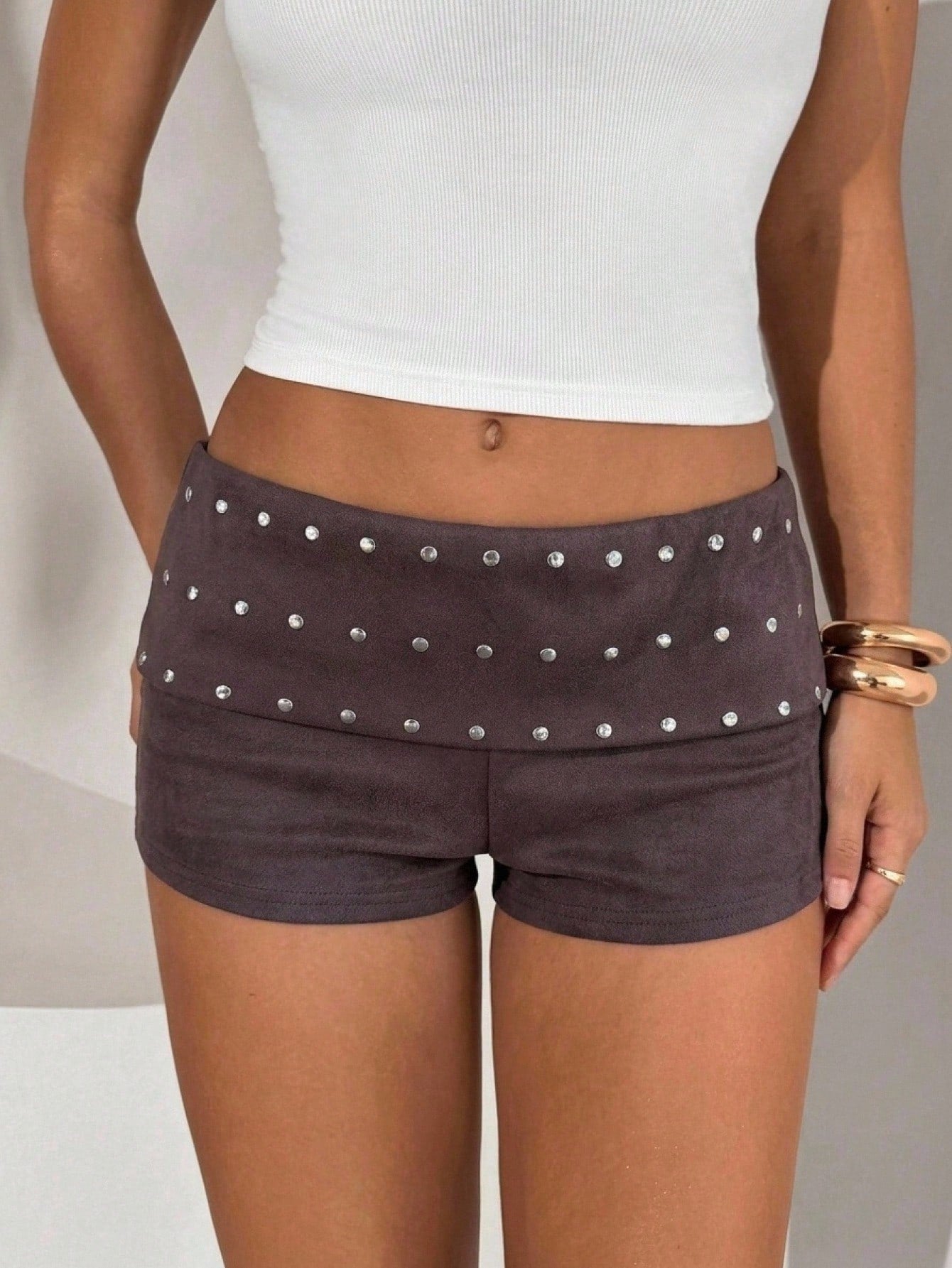Women's studded PU ultra low waist mini shorts with zipper fly closure, skinny fit, mini length, and plain unlined design.