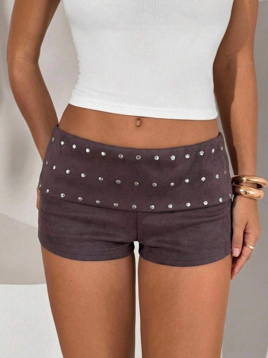 Women's studded PU ultra low waist mini shorts with zipper fly closure, skinny fit, mini length, and plain unlined design.