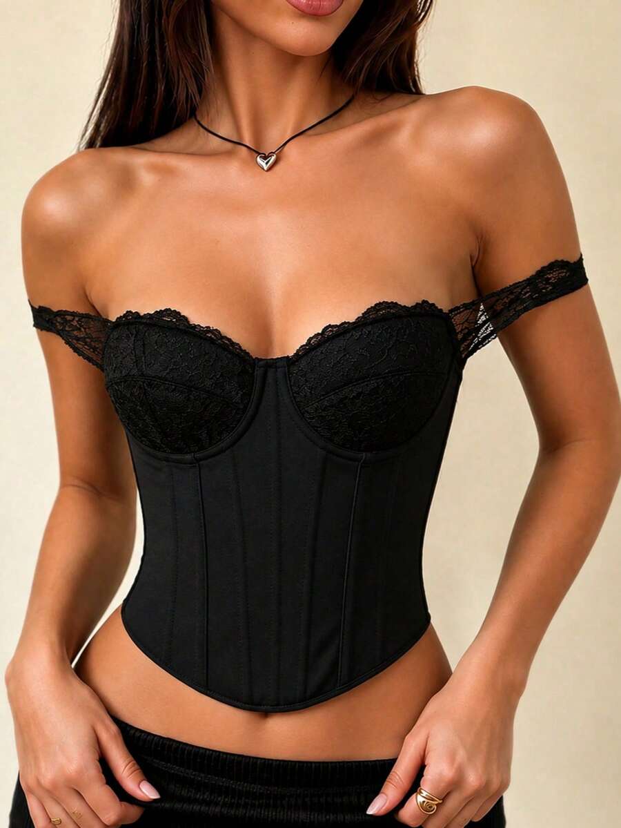Black lace patchwork boned corset bustier crop top with a strapless backless design, cup details, and asymmetrical hem.