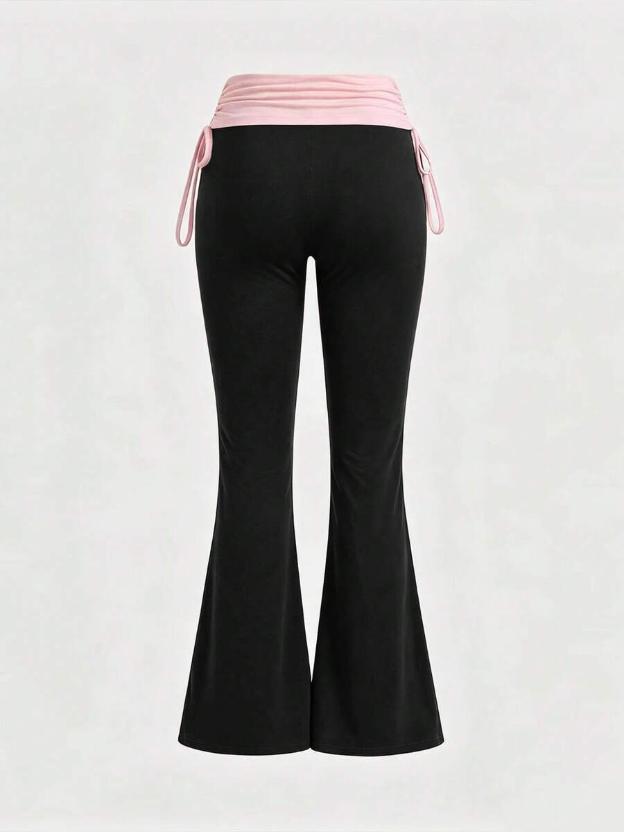 Women's low waist flare leg pants featuring an elastic drawstring waistband and ruched detail in knitted fabric.