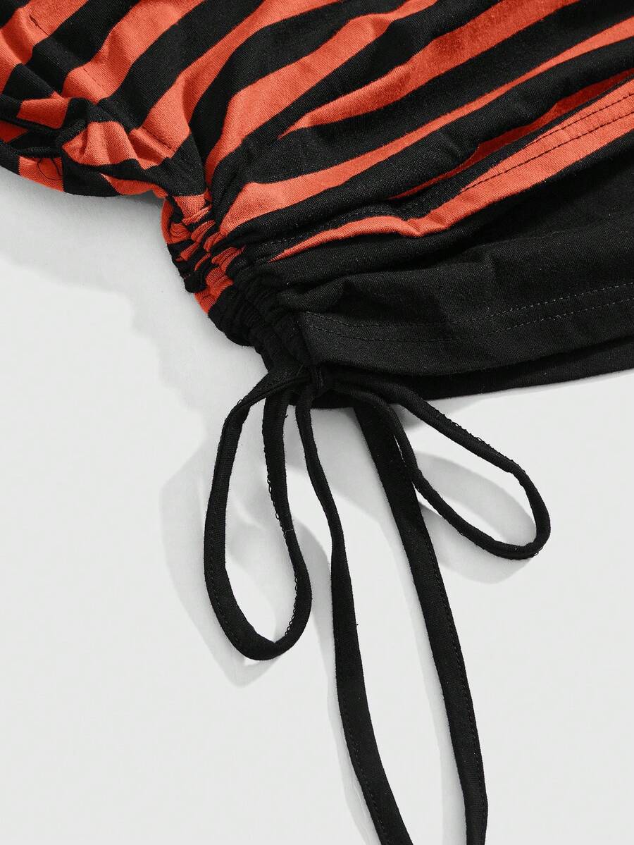 Women's striped t-shirt featuring an asymmetric cold shoulder neckline, batwing short sleeves, and ruched drawstring details in a loose knit fit.