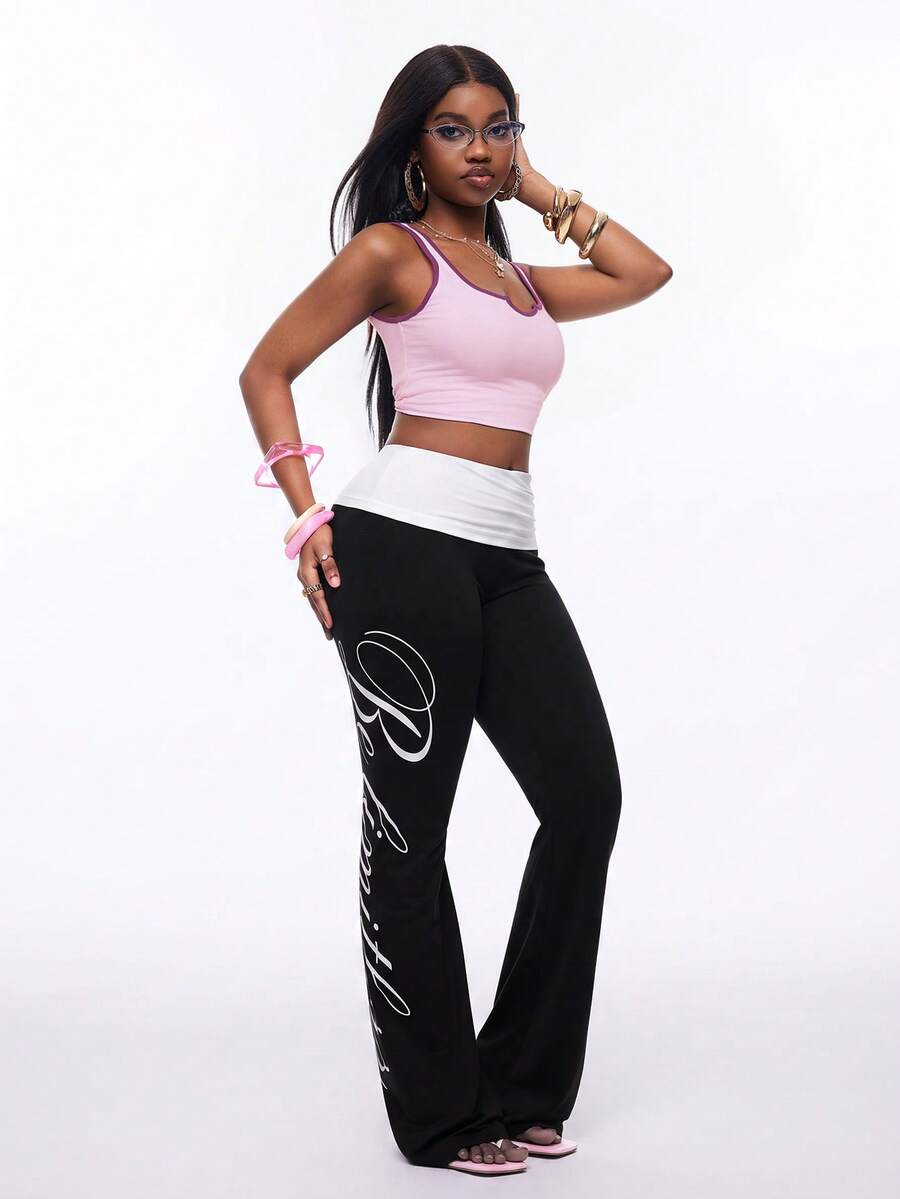 Women's black and white polka dot flare leg pants with side drawstring and ruched details