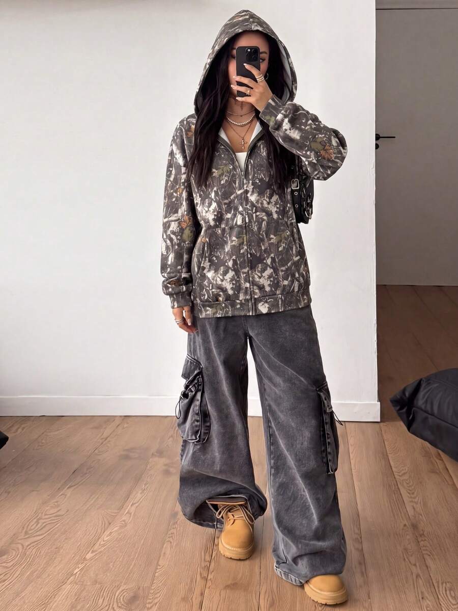 Women's army green camo zip up hoodie with drop shoulder sleeves, front pockets, and drawstring hood