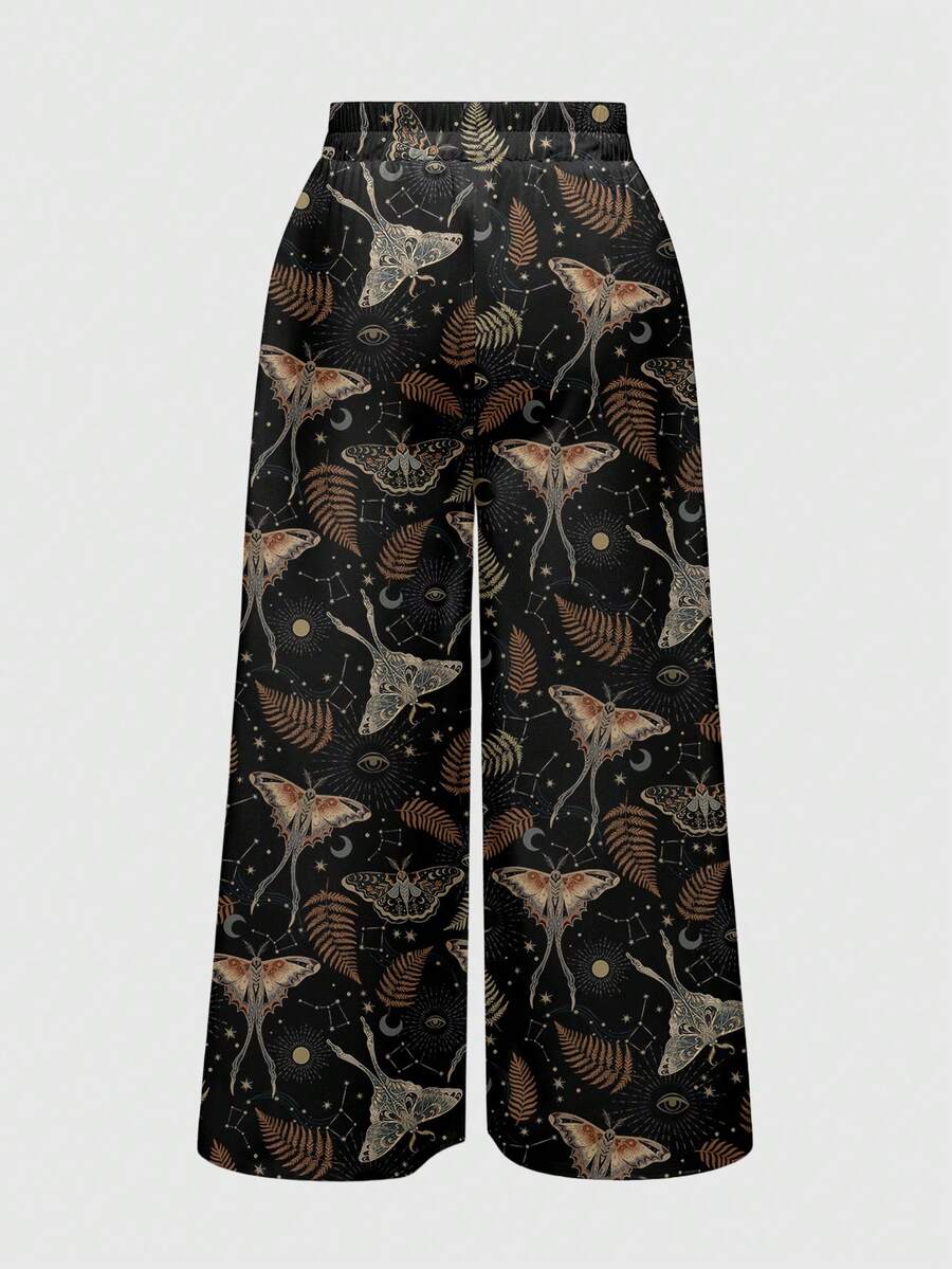 Women's plus size black gothic wide leg pants with split thigh detail and celestial moth, sun, and star pattern.