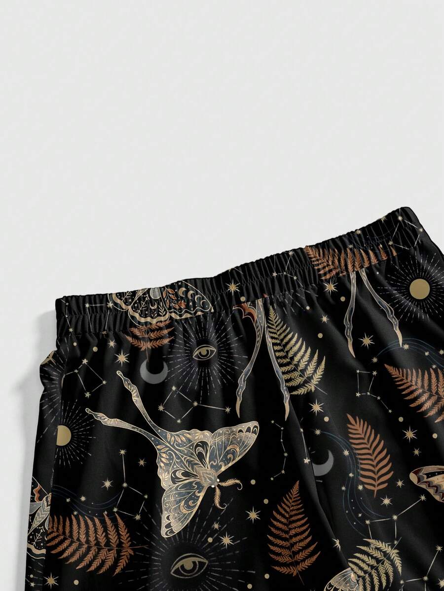 Women's plus size black gothic wide leg pants with split thigh detail and celestial moth, sun, and star pattern.