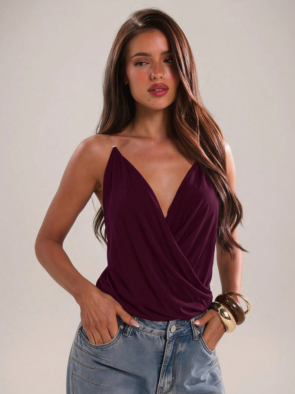 Women's black slim fit spaghetti strap camisole top with a plain design and wrap detail.