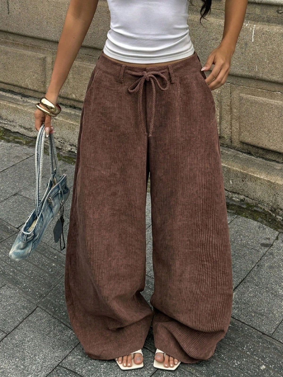 Women's casual straight leg striped woven pants featuring a low waist and zipper fly closure.