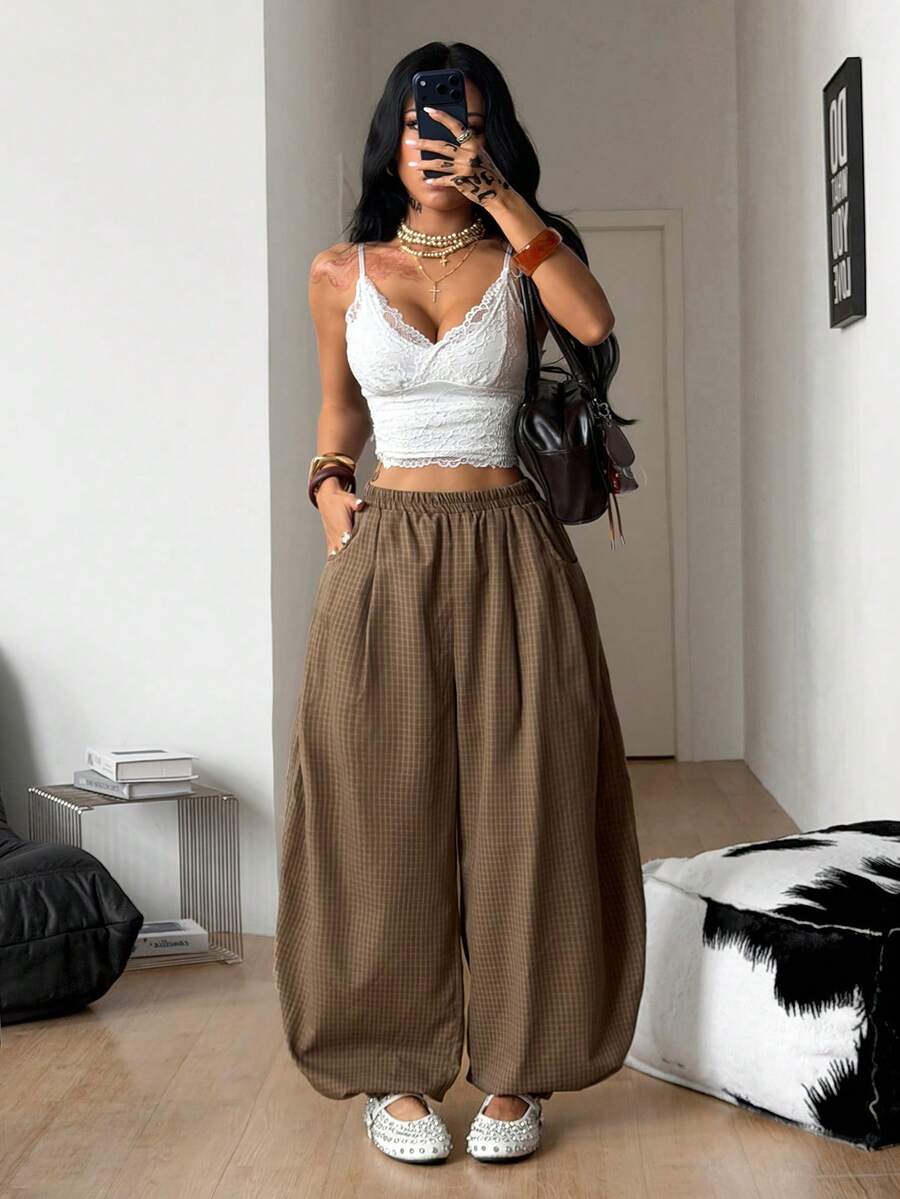 Women's loose-fit black bloomer pants made of 100% cotton featuring an elastic waistband and side pockets.