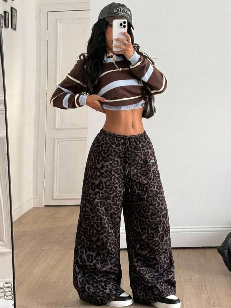 Women's black baggy jogger pants with an adjustable drawstring waist and colorblock polka dot geometric pattern.