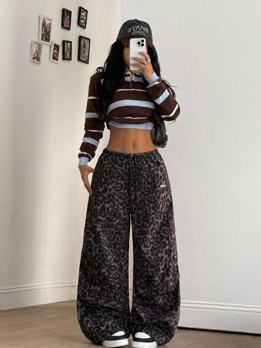 Women's black baggy jogger pants with an adjustable drawstring waist and colorblock polka dot geometric pattern.