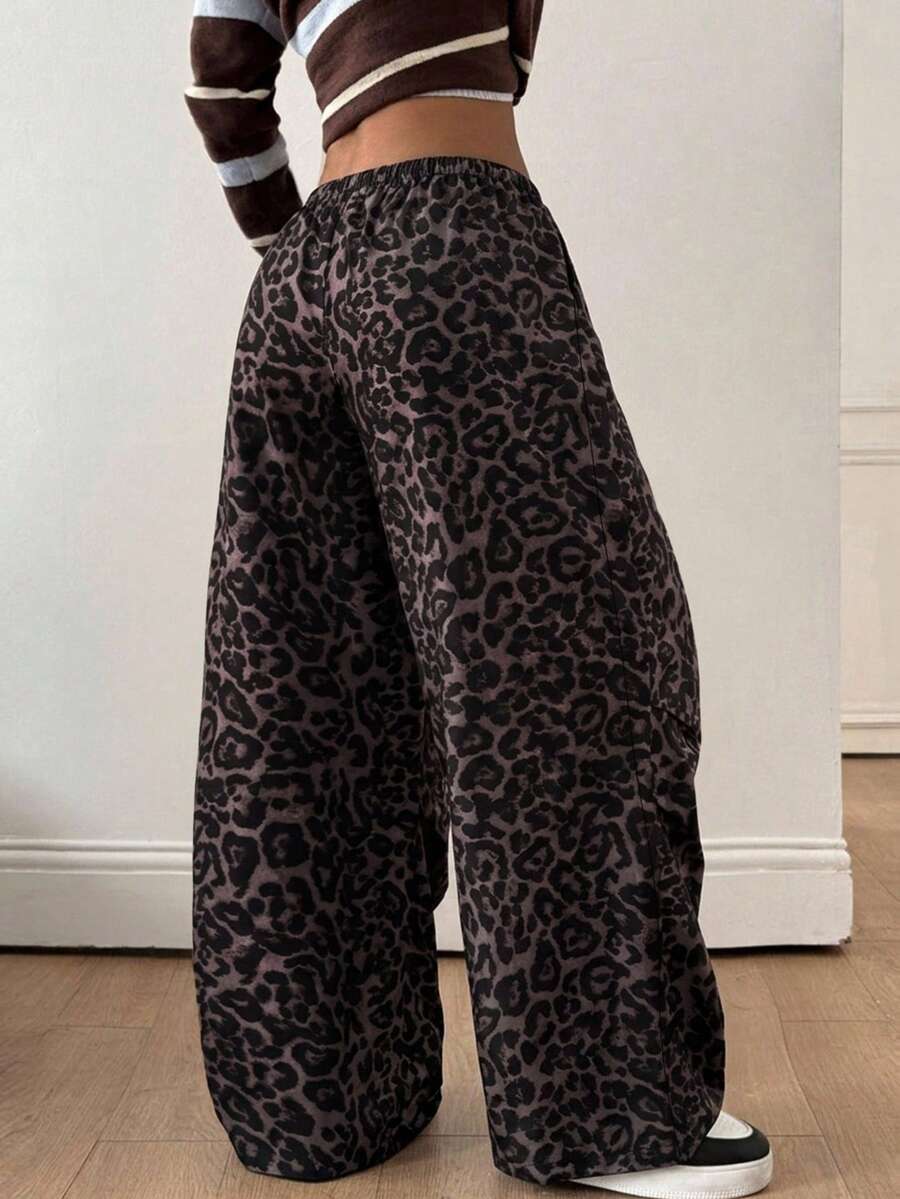 Women's black baggy jogger pants with an adjustable drawstring waist and colorblock polka dot geometric pattern.