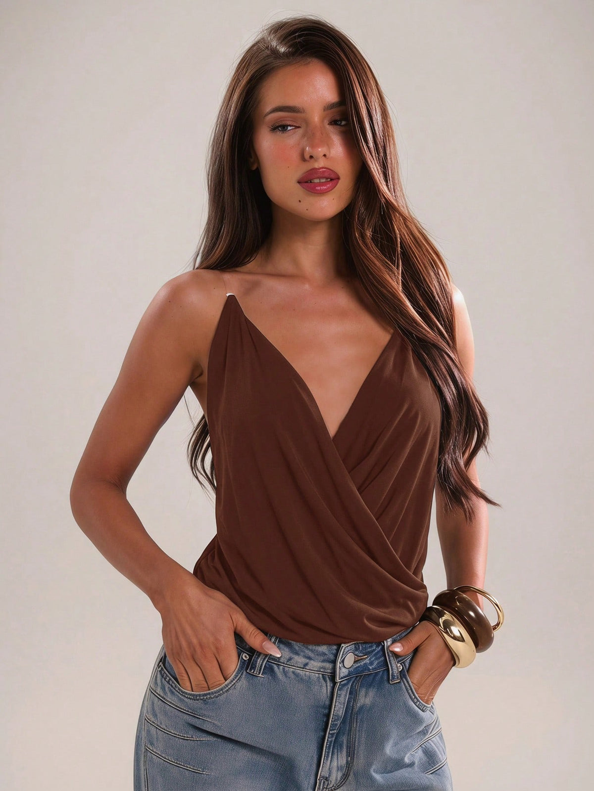 Women's black slim fit spaghetti strap camisole top with a plain design and wrap detail.