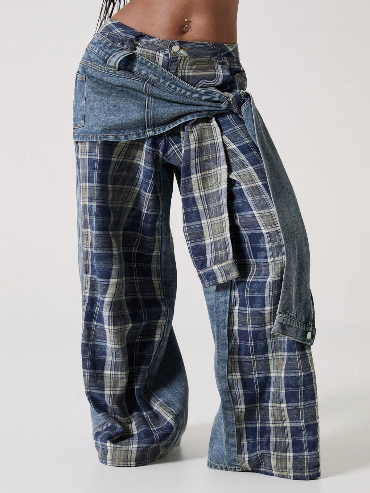Women's plus size blue patchwork denim jeans featuring front lace-up detailing, mid waist, zipper fly, and functional pockets.