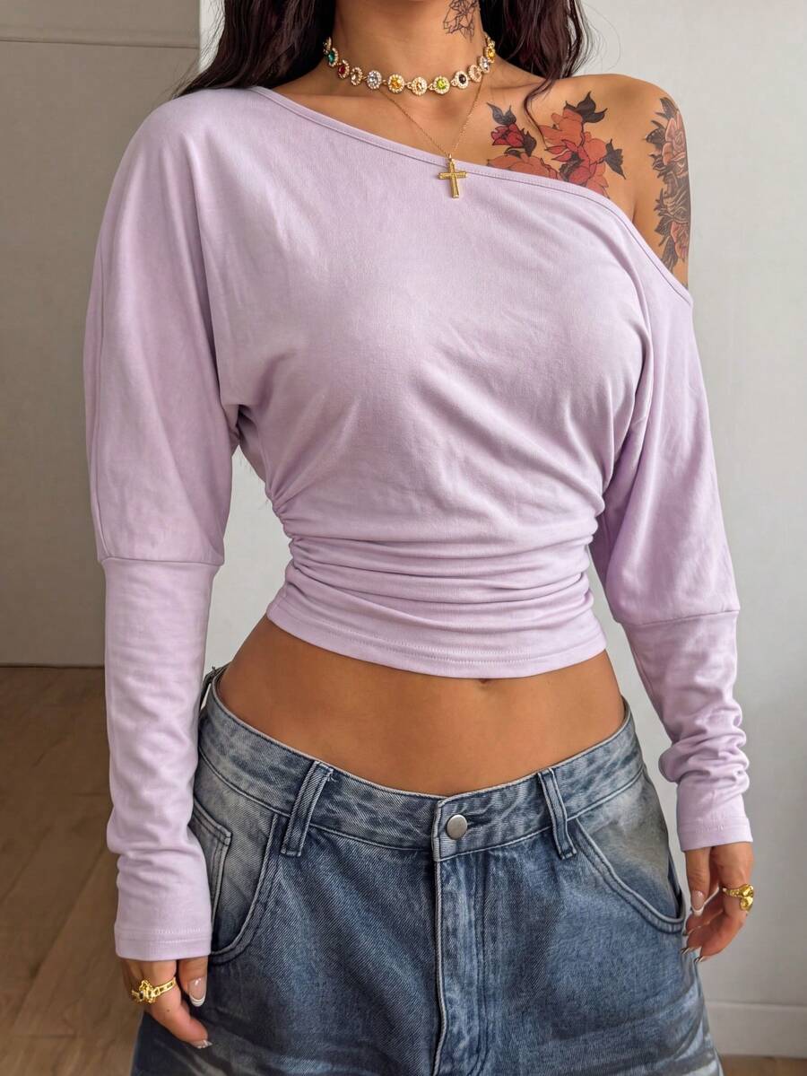 Women's black long sleeve t-shirt featuring delicate contrast lace details and a boat neckline in a knitted stretch fabric.