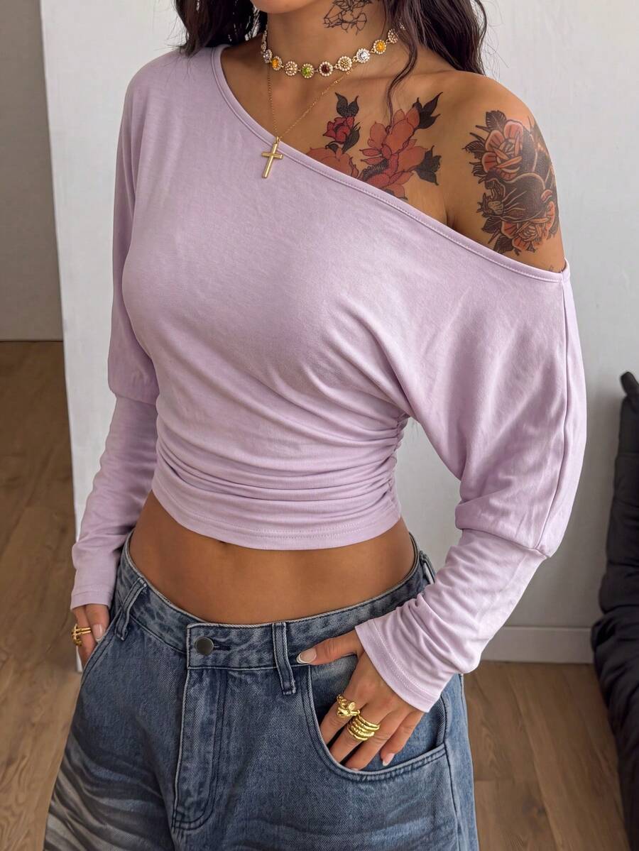 Women's black long sleeve t-shirt featuring delicate contrast lace details and a boat neckline in a knitted stretch fabric.