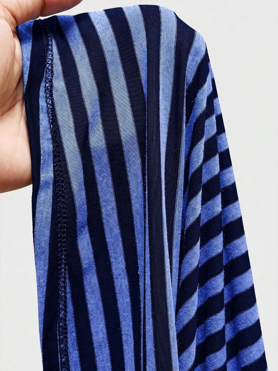 Women's striped strapless tube top featuring ruched detailing, flared hem, and stretchy knit fabric.