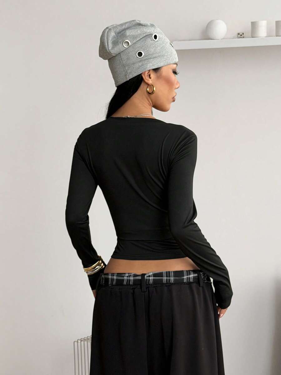 Women's fitted long sleeve rib-knit top featuring a deep V-neckline with delicate contrast lace detailing.