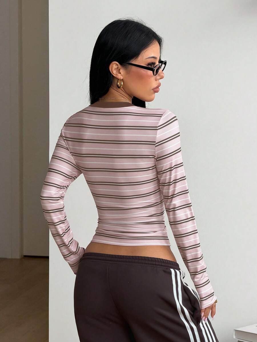 Women's fitted long sleeve rib-knit top featuring a deep V-neckline with delicate contrast lace detailing.