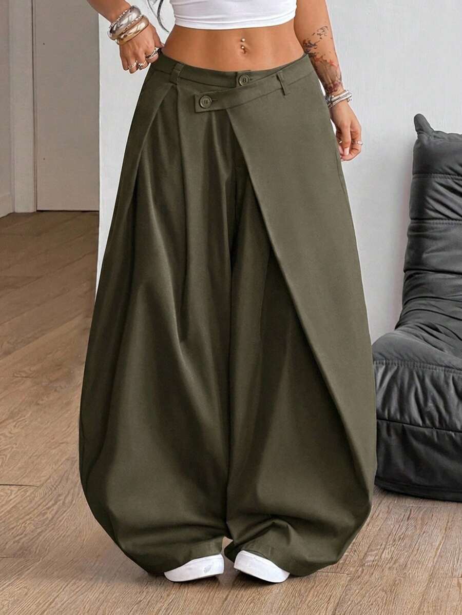 Women's army green baggy bloomer pants featuring a loose curved silhouette, low waist, functional pockets, and zipper fly closure.