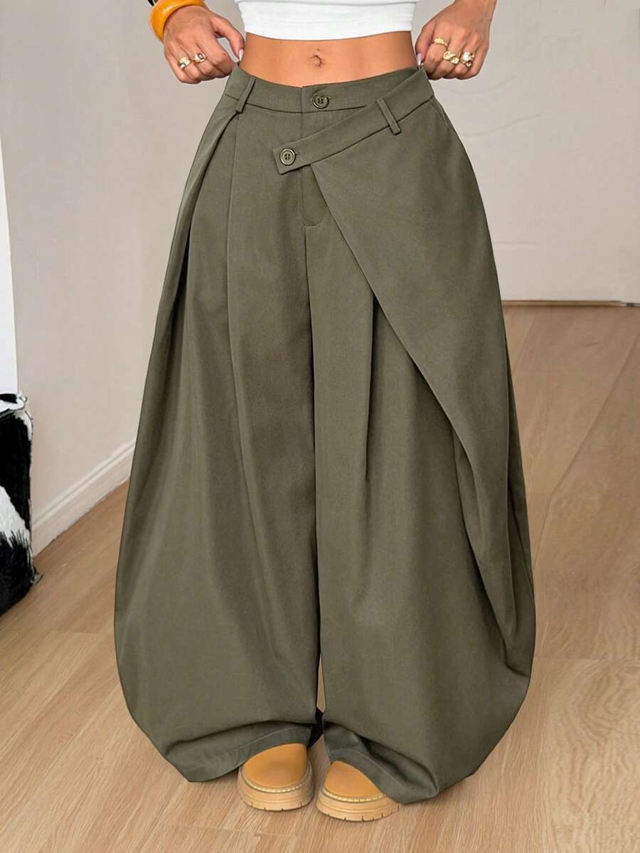 Women's army green baggy bloomer pants featuring a loose curved silhouette, low waist, functional pockets, and zipper fly closure.
