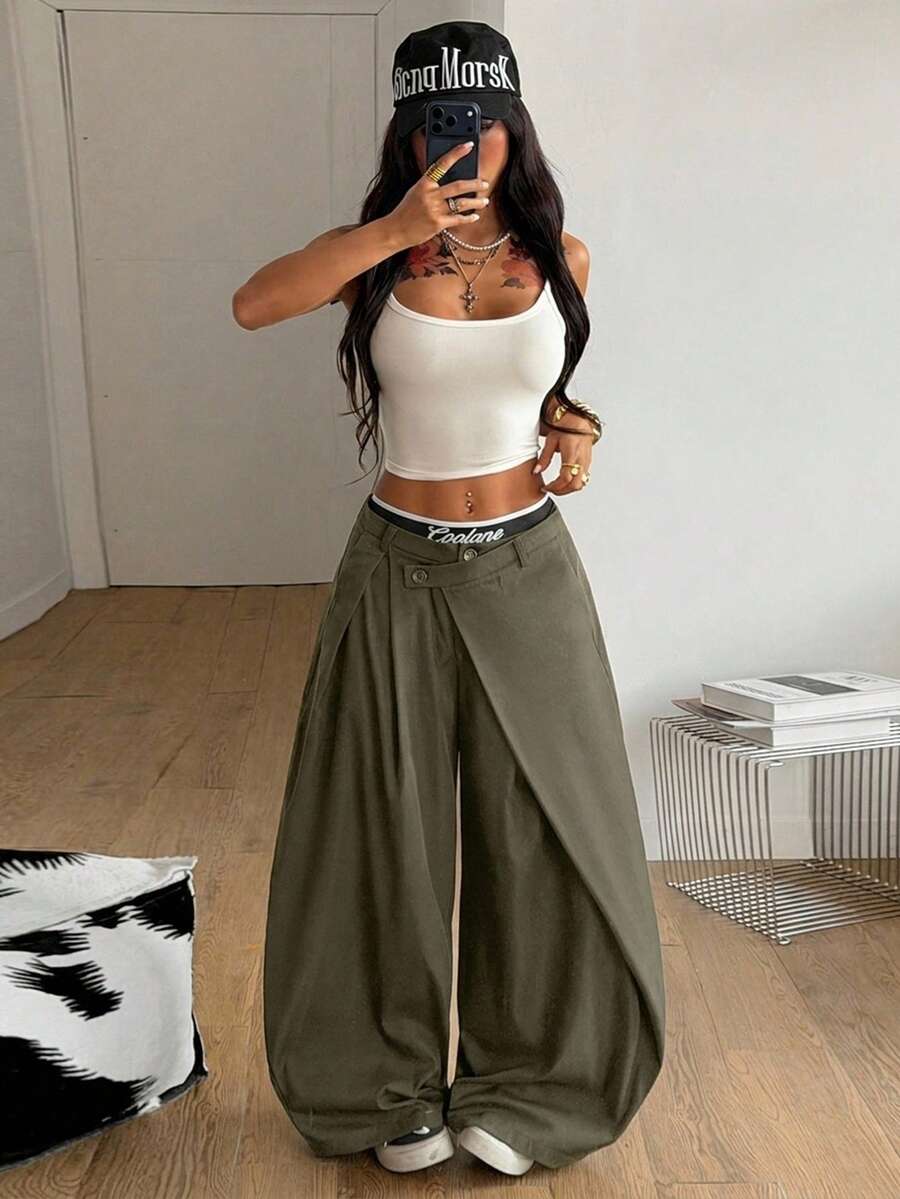 Women's army green baggy bloomer pants featuring a loose curved silhouette, low waist, functional pockets, and zipper fly closure.
