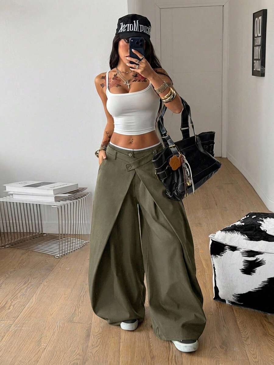 Women's army green baggy bloomer pants featuring a loose curved silhouette, low waist, functional pockets, and zipper fly closure.