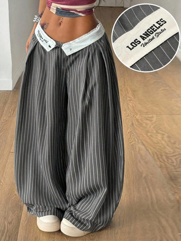 Women's loose fit dark grey harem pants featuring an elastic low waist, side pockets, and a wide leg casual streetwear cut.