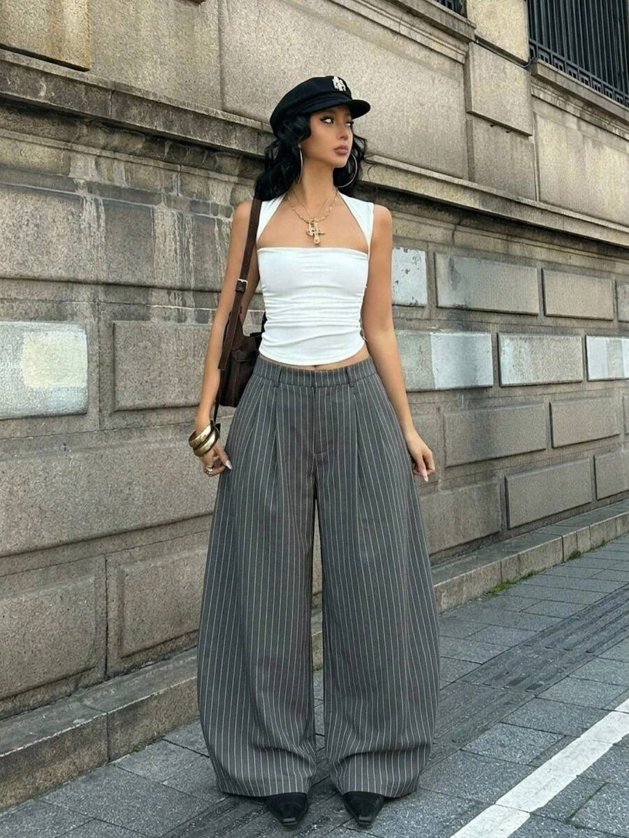 Women's loose fit dark grey harem pants featuring an elastic low waist, side pockets, and a wide leg casual streetwear cut.