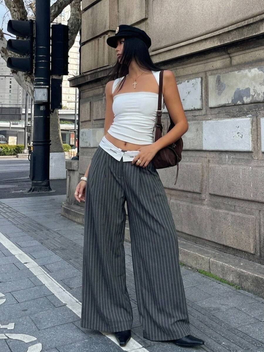 Women's loose fit dark grey harem pants featuring an elastic low waist, side pockets, and a wide leg casual streetwear cut.
