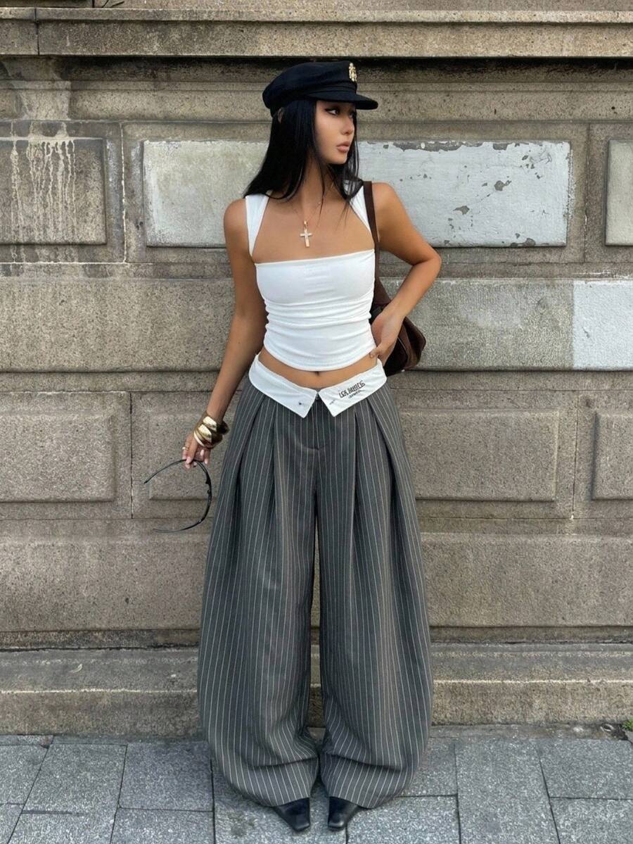Women's loose fit dark grey harem pants featuring an elastic low waist, side pockets, and a wide leg casual streetwear cut.