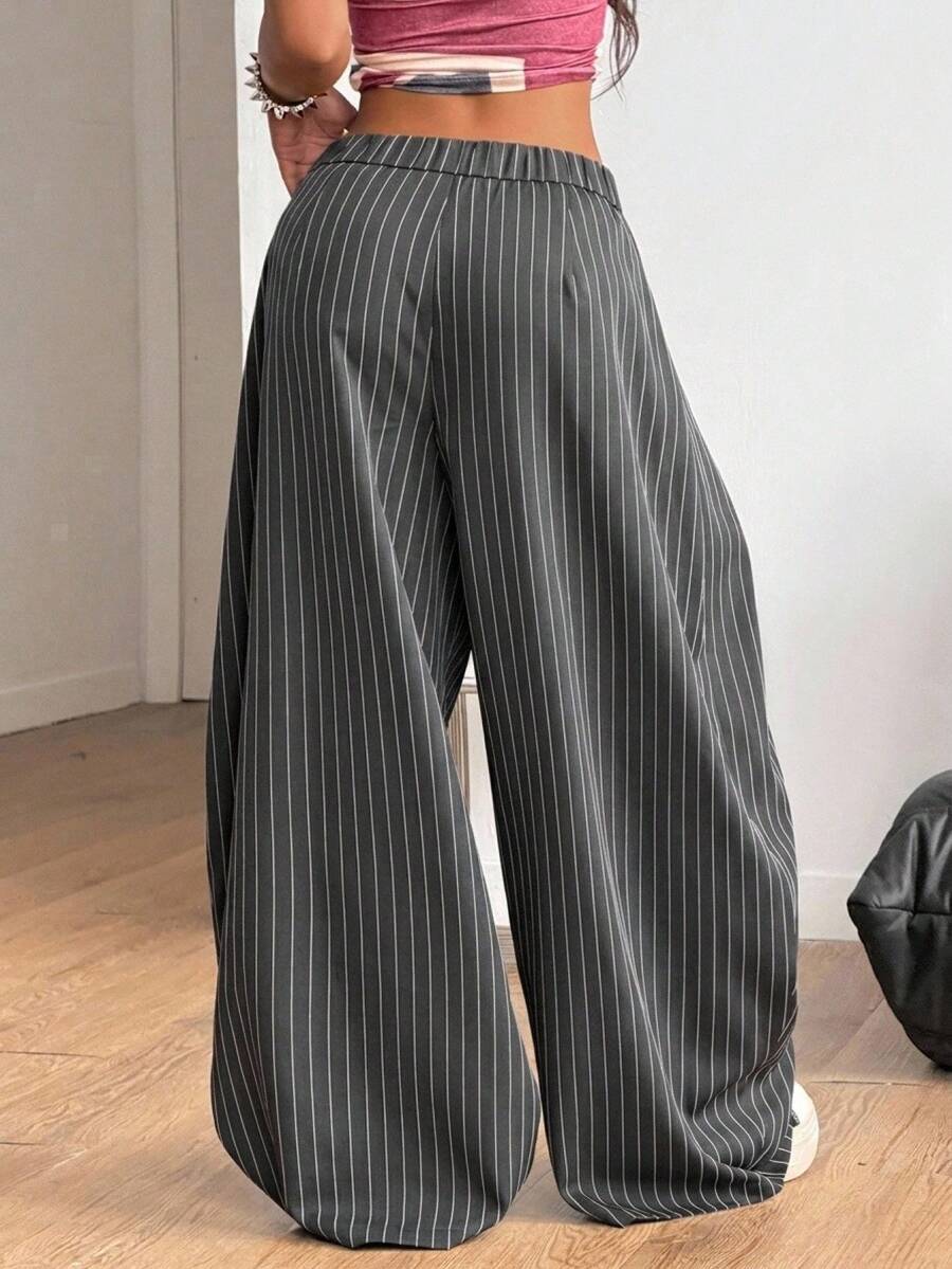 Women's loose fit dark grey harem pants featuring an elastic low waist, side pockets, and a wide leg casual streetwear cut.