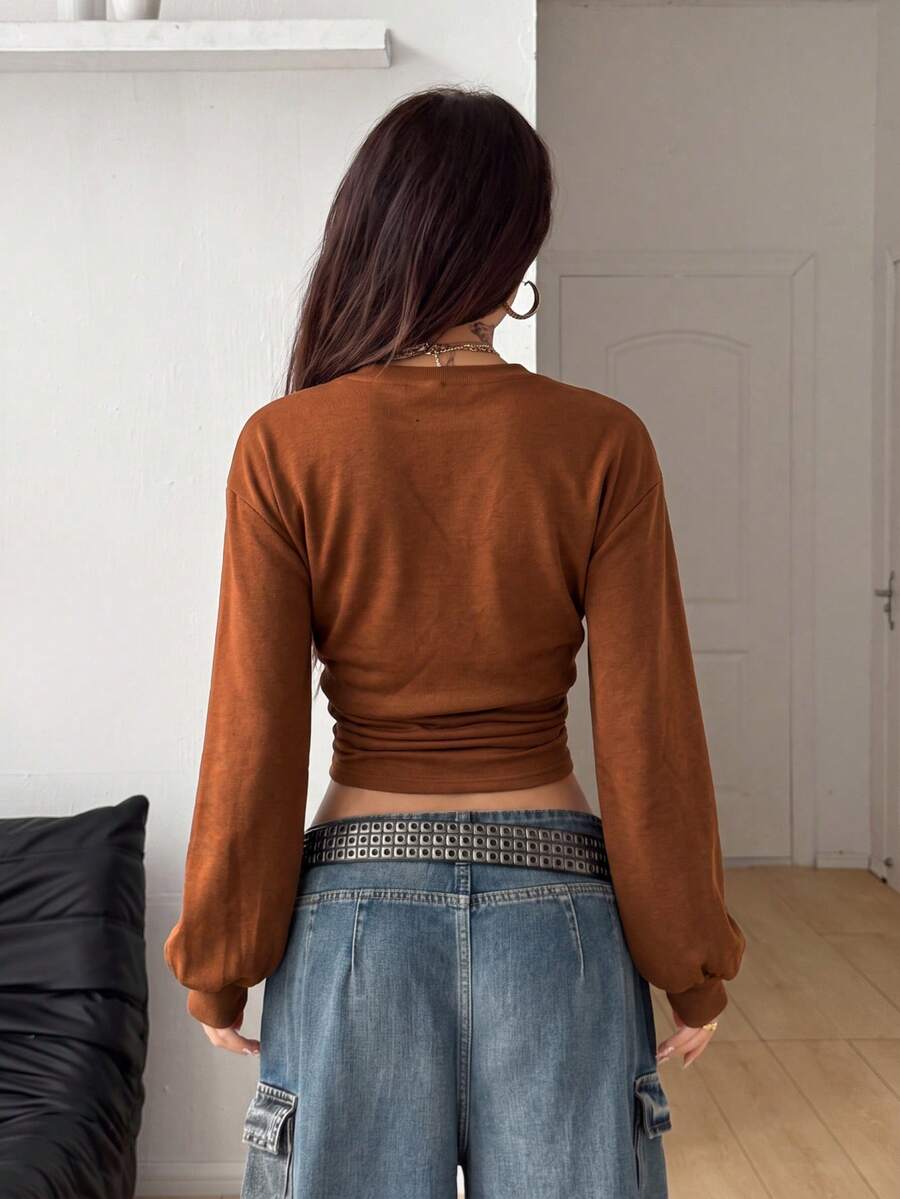 Women's brown waist-cinching sweatshirt featuring a round neck, drop shoulder long sleeves, and rib-knit cuffs.