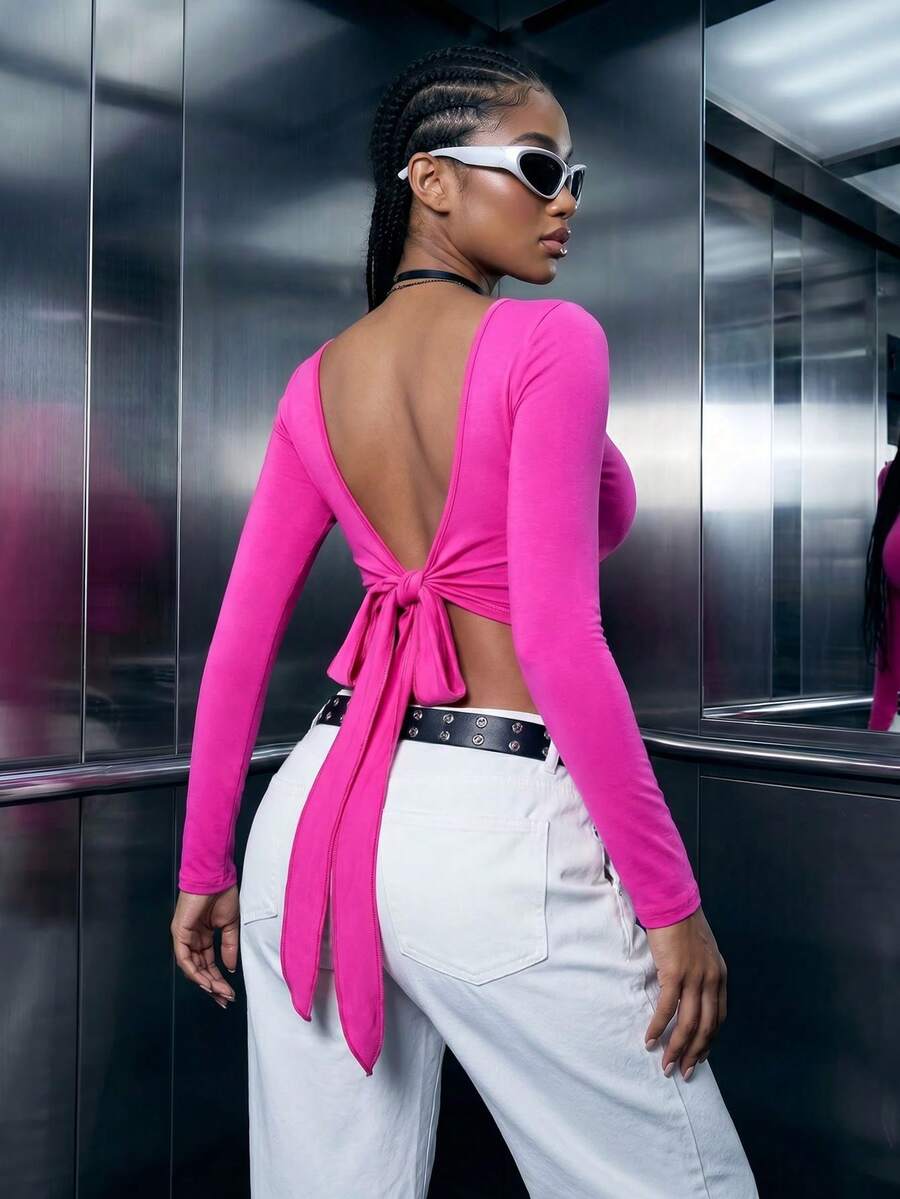 Women's mint blue cropped long sleeve top featuring a deep V-neck and twist knot asymmetrical front hem.